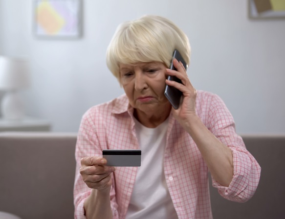 Woman talking on the phone to depict ecommerce fraud victim