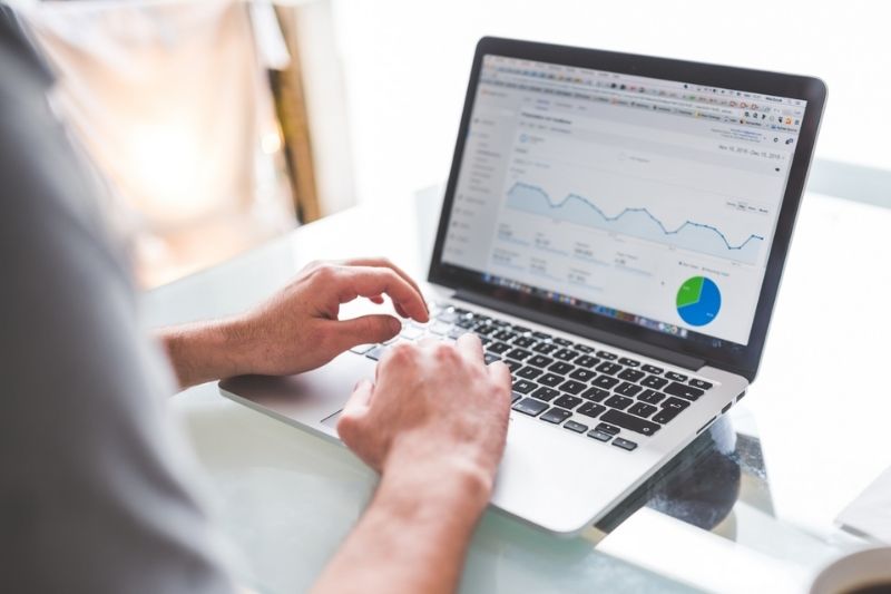 Merchant looking at subscription data on laptop