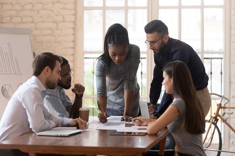 A group of workers calculating subscription revenue