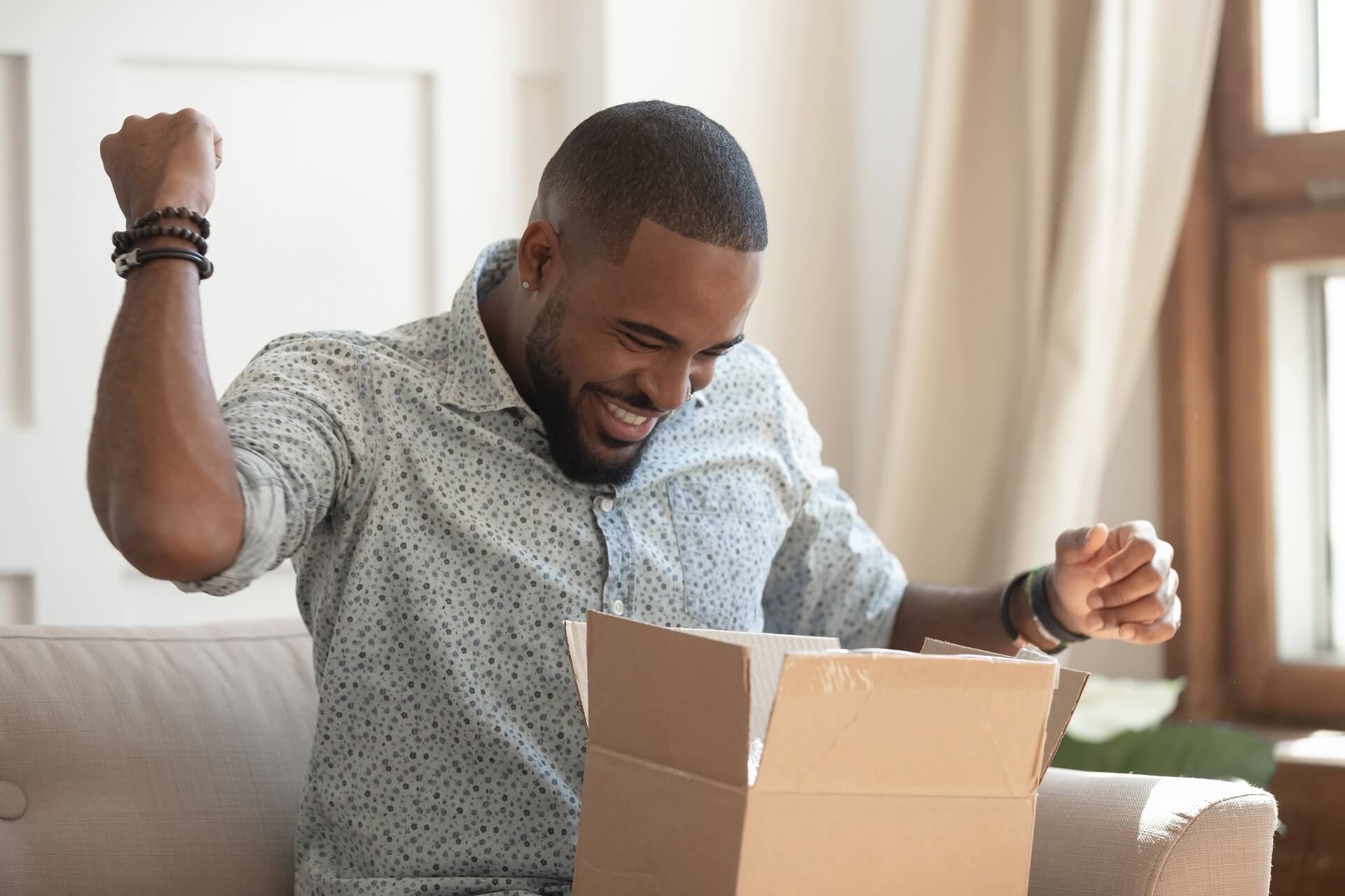 Happy customer opening subscription box to signify reducing subscription churn