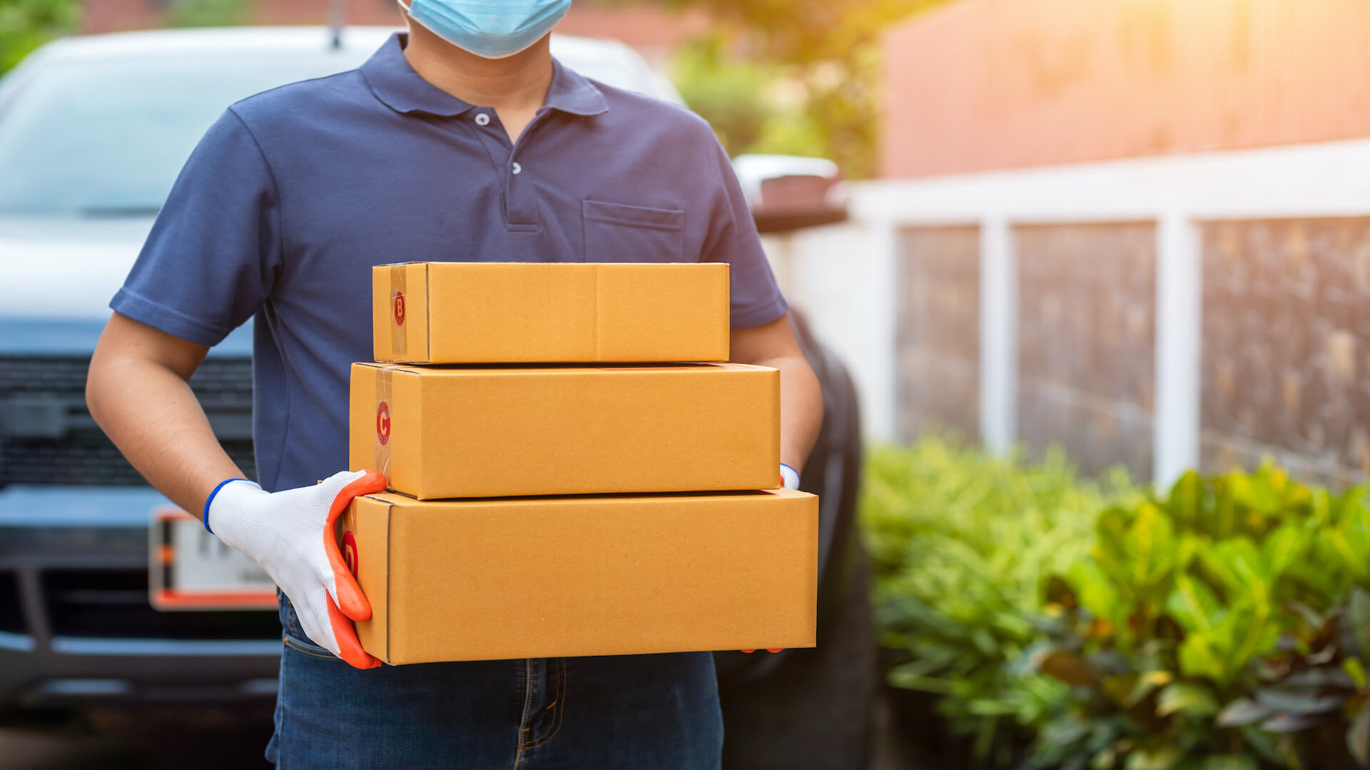 Delivery man with subscription boxes to signify subscription revenue