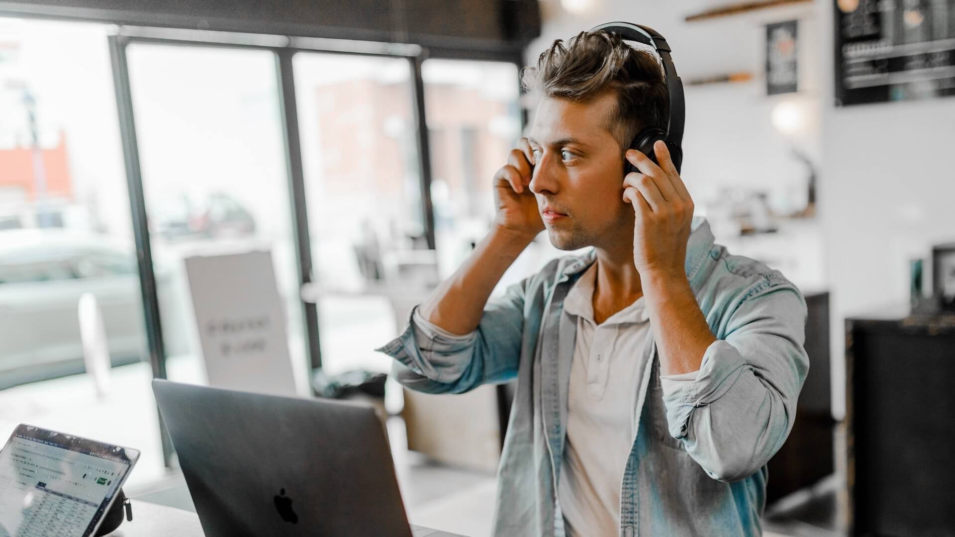 Man listening to music on his laptop instead of attending concert
