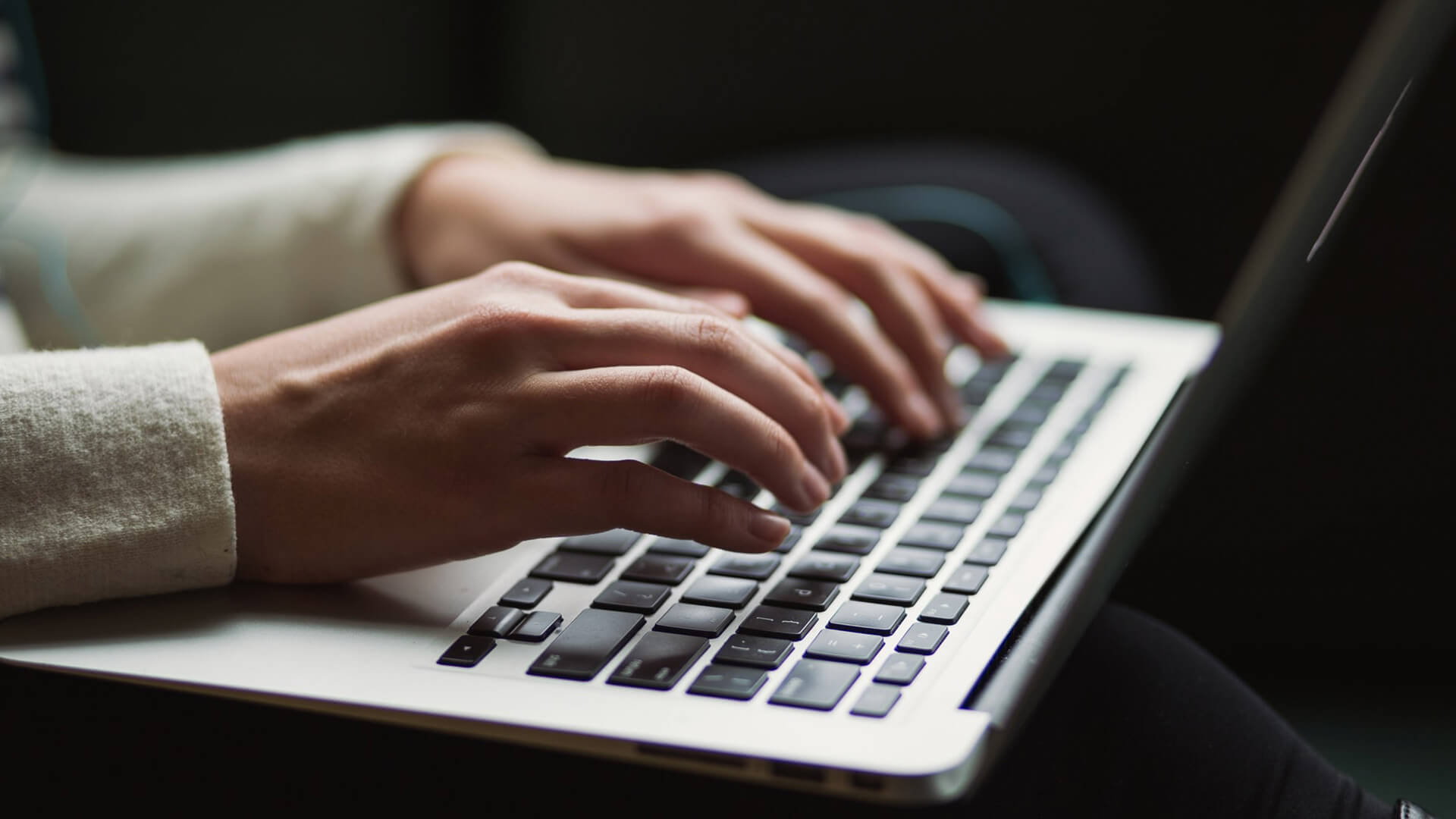 A person typing on a laptop to learn more about headless commerce